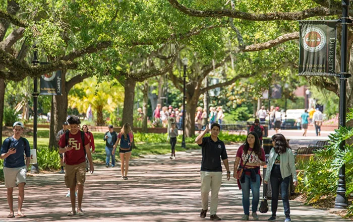 College student choosing healthy foods in cafeteria to support metabolic health and avoid weight gain