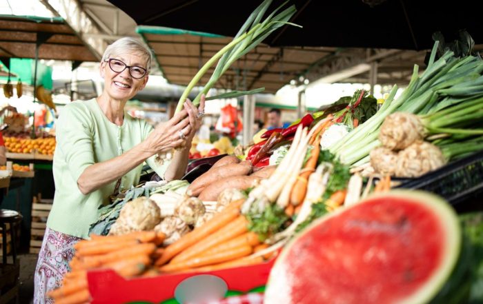 Healthy woman over 50 enjoying a balanced meal while learning how proper nutrition, metabolism, and healthy aging support energy and weight management.