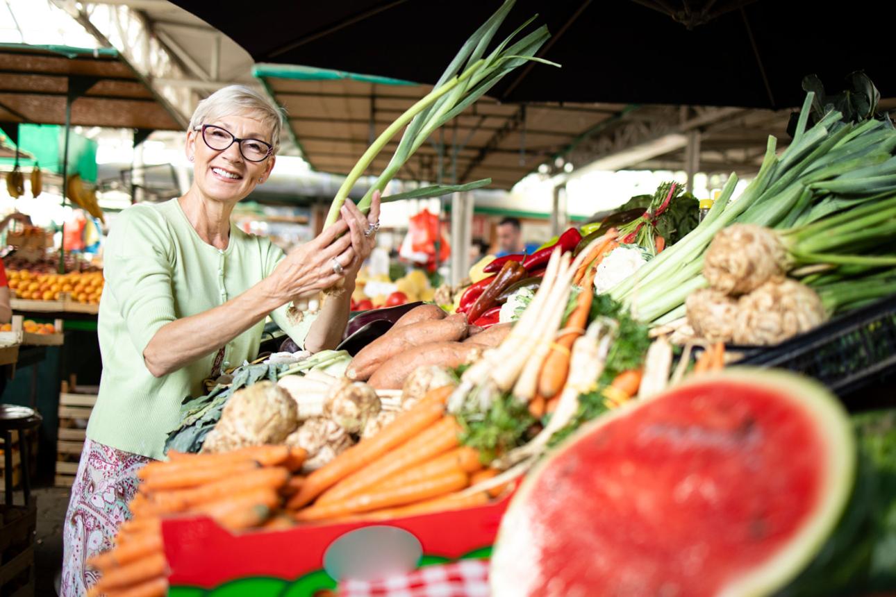 Healthy woman over 50 enjoying a balanced meal while learning how proper nutrition, metabolism, and healthy aging support energy and weight management.